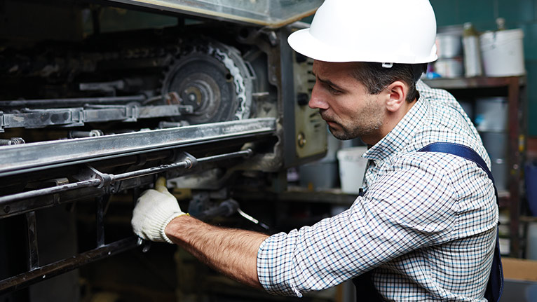 Worker performing maintenance work on the machine