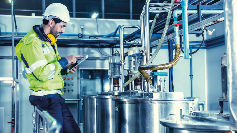 A technician checks the production system